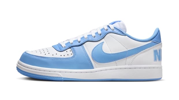 Side view of a blue and white Nike sneaker.